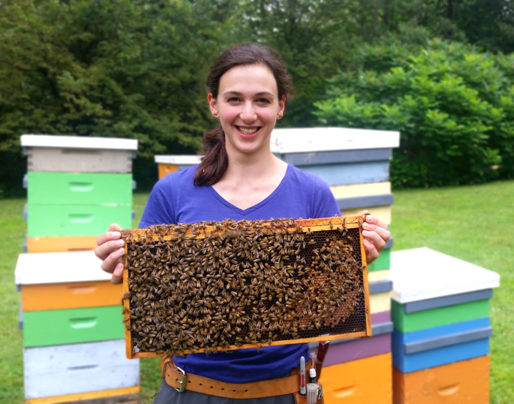 Stephanie Otto holding a hive